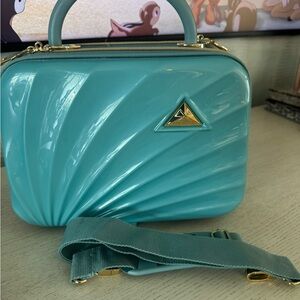 Teal cosmetic travel bag with shoulder strap